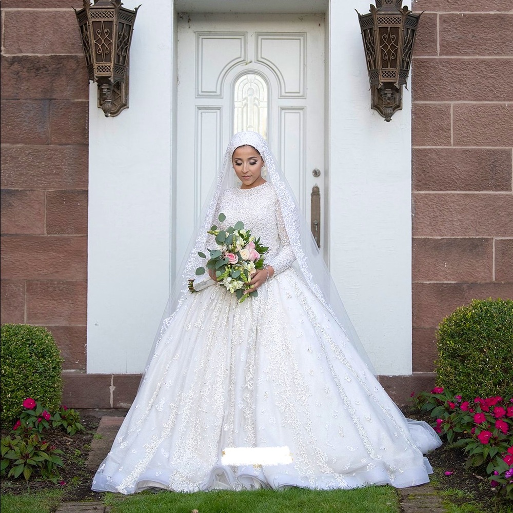 Beaded ball gown wedding dress with headpiece (if needed) and long veil.